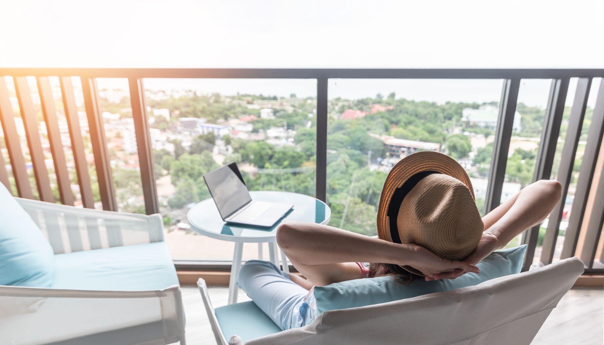 woman resting in resort hotel balcony having peace of mind