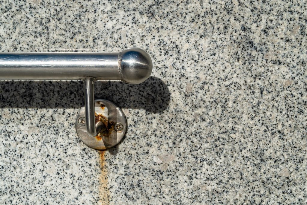 rusty handle on stone wall