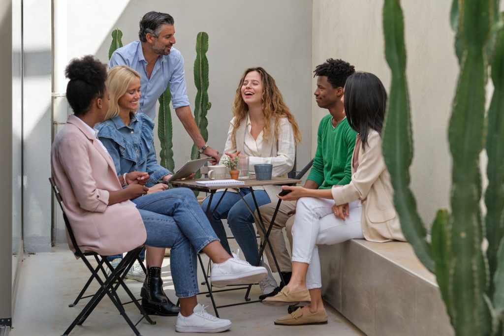 smiling people sitting at table